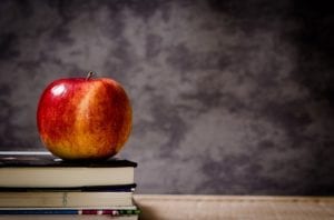 an apple on a stack of books