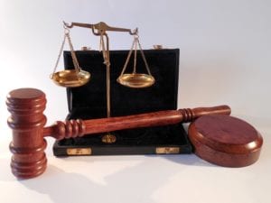a judge's hammer, and a set of scales, signifying justice