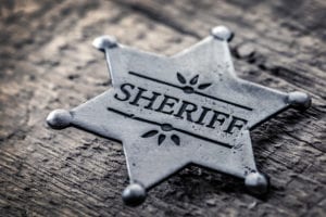 a silver sheriff's badge