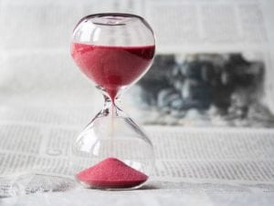 An hourglass with the sand running through it