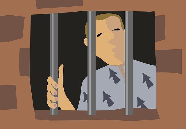 A cartoon of a man behind bars in prison, looking out of a window